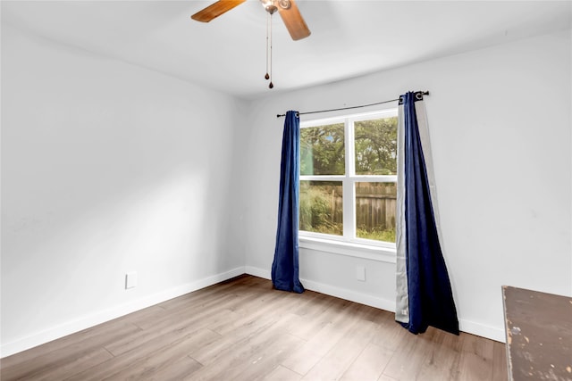 unfurnished room with light wood-type flooring and ceiling fan