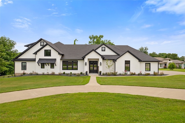 modern inspired farmhouse with a front lawn