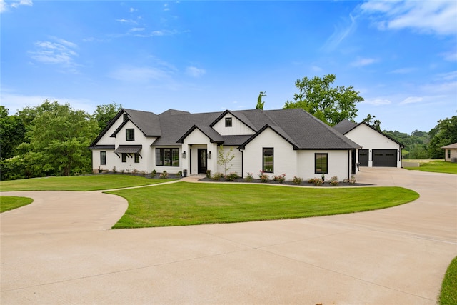 view of front of home featuring a front yard and a garage