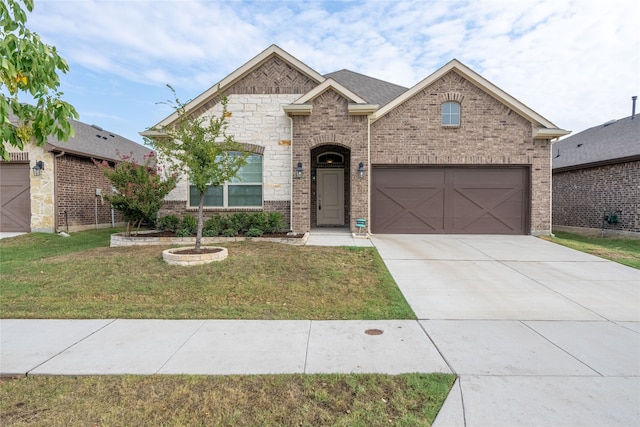 view of front of house featuring a garage and a front lawn