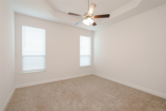 carpeted spare room with ceiling fan