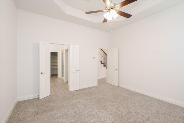 unfurnished bedroom with light colored carpet and ceiling fan