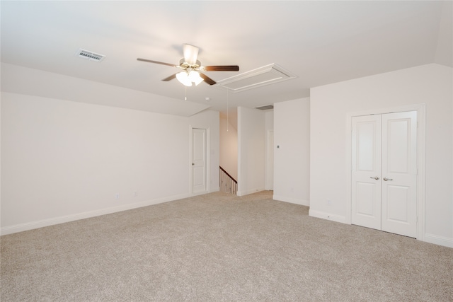 unfurnished bedroom featuring light colored carpet, ceiling fan, and a closet