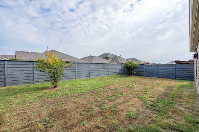 view of yard with a fenced backyard