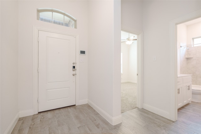 entryway featuring a wealth of natural light, ceiling fan, and light hardwood / wood-style floors