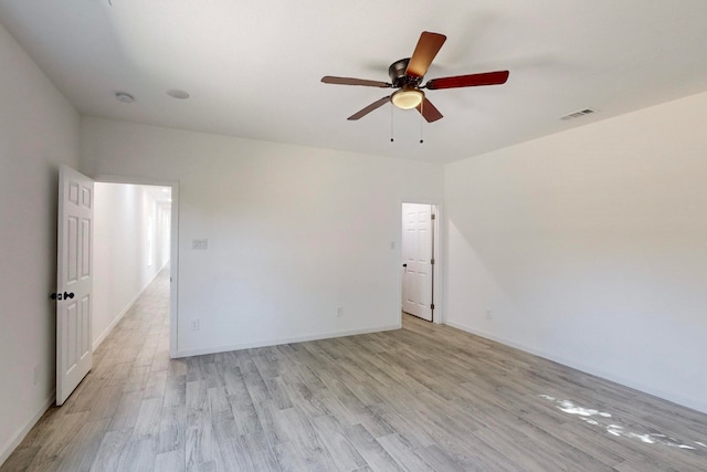 unfurnished room with light wood-type flooring and ceiling fan