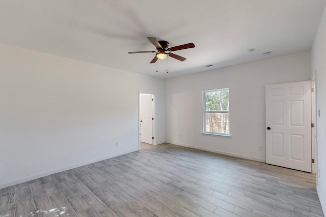 unfurnished room with light wood-type flooring and ceiling fan