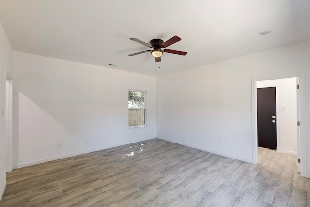 spare room featuring ceiling fan and light hardwood / wood-style floors