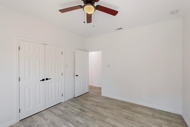 unfurnished bedroom with a closet, ceiling fan, and light hardwood / wood-style floors