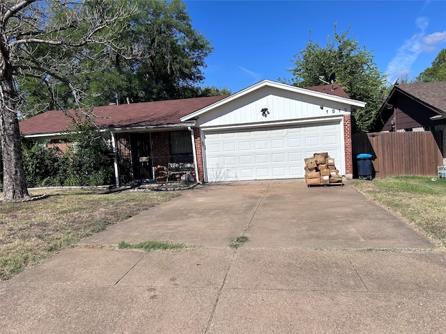 single story home featuring a front yard and a garage