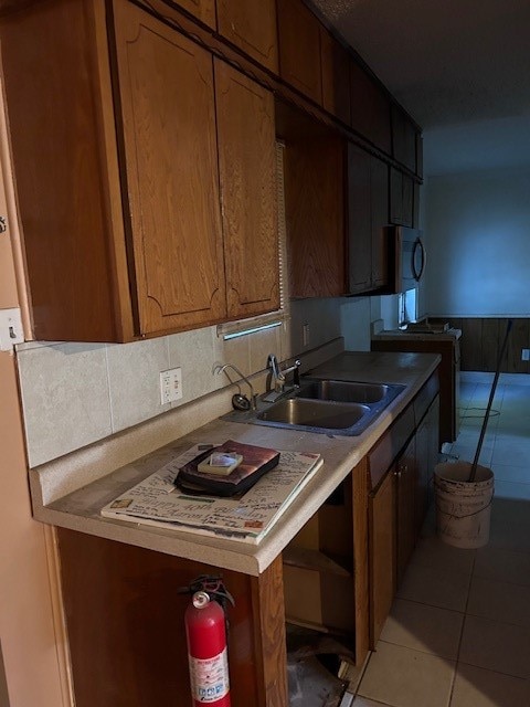 kitchen with light tile patterned flooring and sink