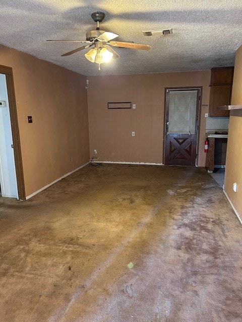 spare room featuring a textured ceiling and ceiling fan