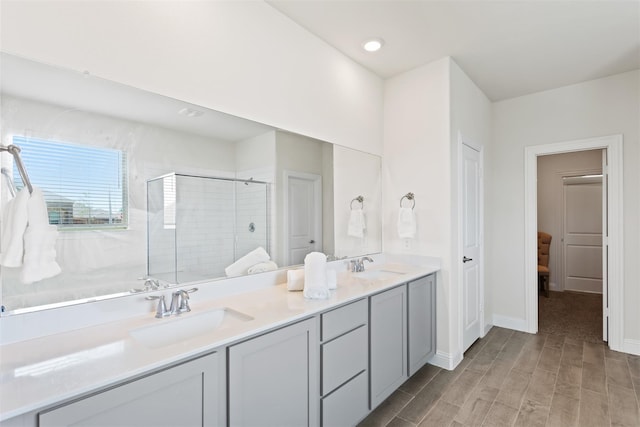 bathroom featuring hardwood / wood-style floors, an enclosed shower, and vanity