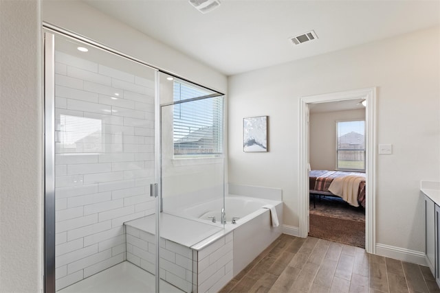 bathroom with vanity, separate shower and tub, and hardwood / wood-style floors