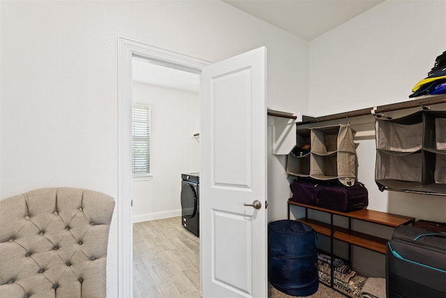 spacious closet with light hardwood / wood-style flooring