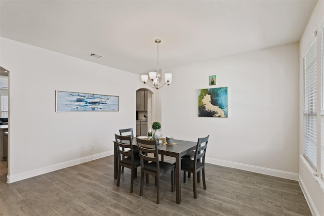 dining room featuring dark hardwood / wood-style floors and a chandelier