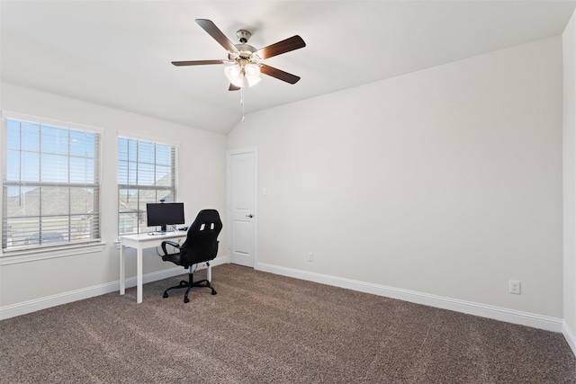 carpeted home office featuring lofted ceiling and ceiling fan