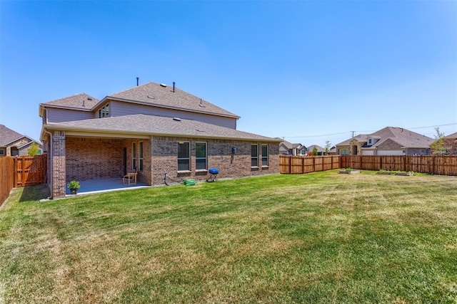 rear view of property with a lawn and a patio