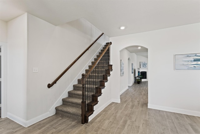 stairway with hardwood / wood-style flooring