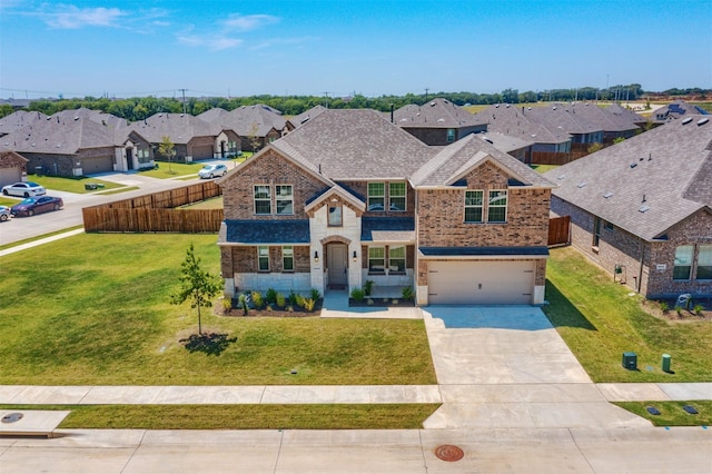 craftsman inspired home with a garage and a front lawn