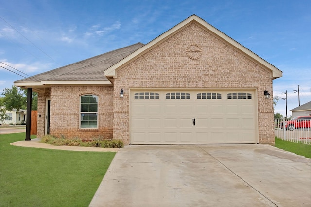 view of front of home with a front lawn and a garage