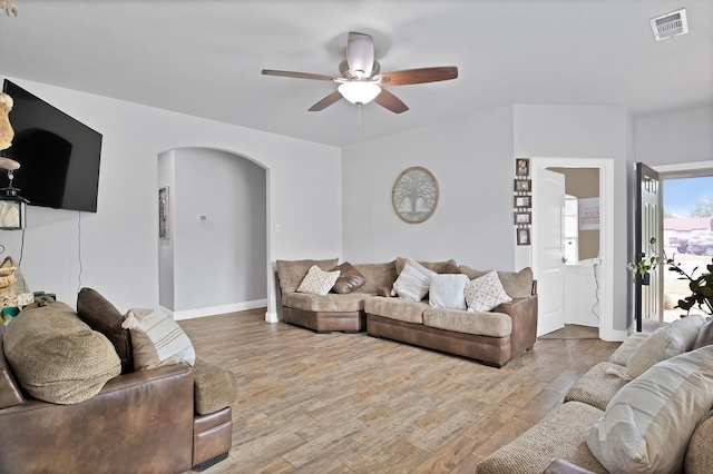 living room featuring light wood-type flooring and ceiling fan