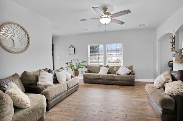 living room featuring light wood-type flooring and ceiling fan