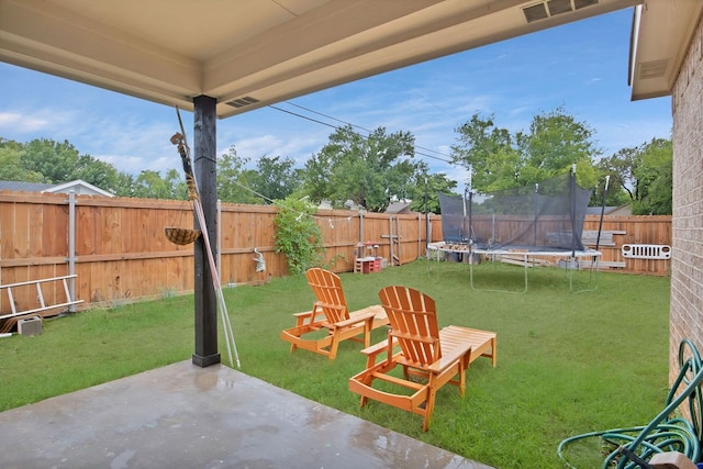 view of yard featuring a patio and a trampoline