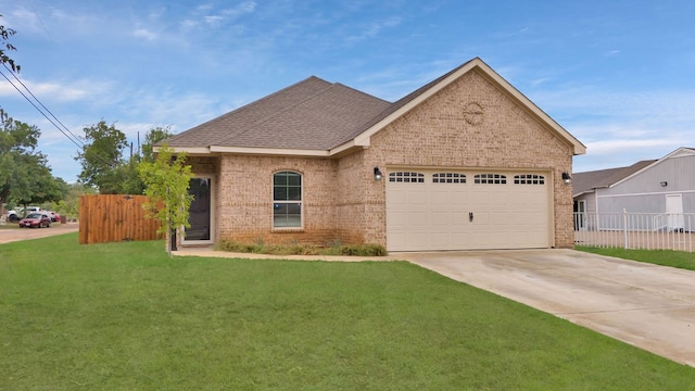 view of front of home with a garage and a front lawn