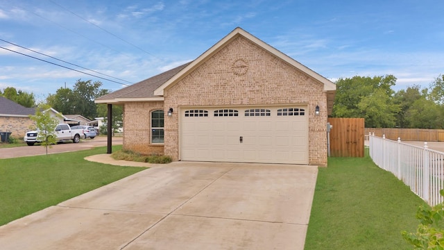 view of front of home with a garage and a front lawn