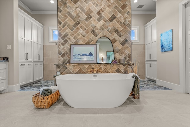 bathroom featuring a tub to relax in, tile walls, and ornamental molding