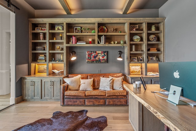 sitting room featuring light hardwood / wood-style flooring and beam ceiling