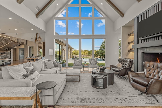 living room with high vaulted ceiling and beamed ceiling