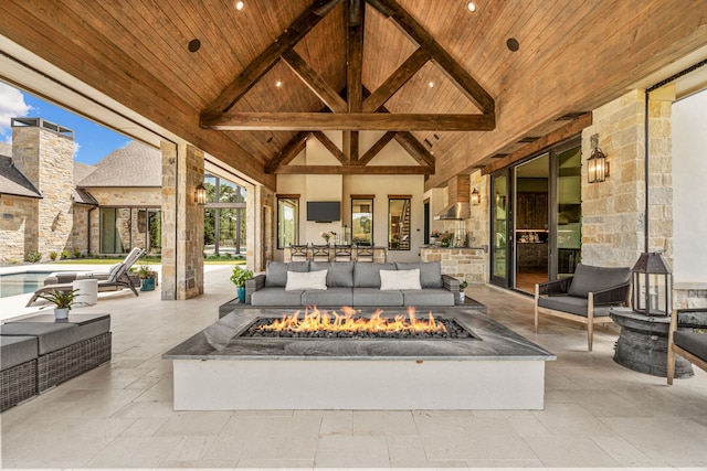 view of patio with an outdoor living space with a fire pit