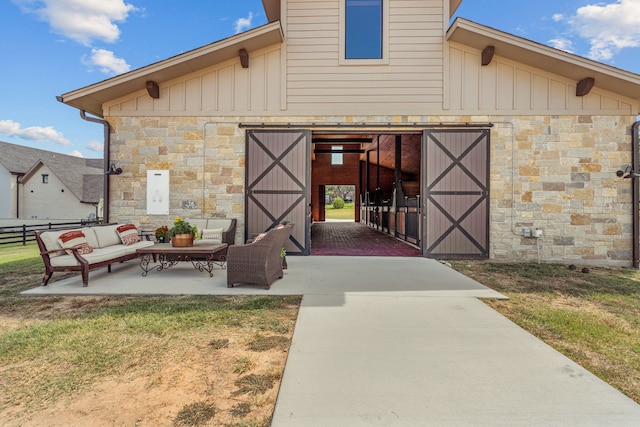 property entrance featuring an outdoor hangout area and a patio area