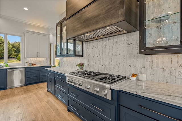 kitchen with ornamental molding, tasteful backsplash, light hardwood / wood-style flooring, stainless steel appliances, and custom range hood