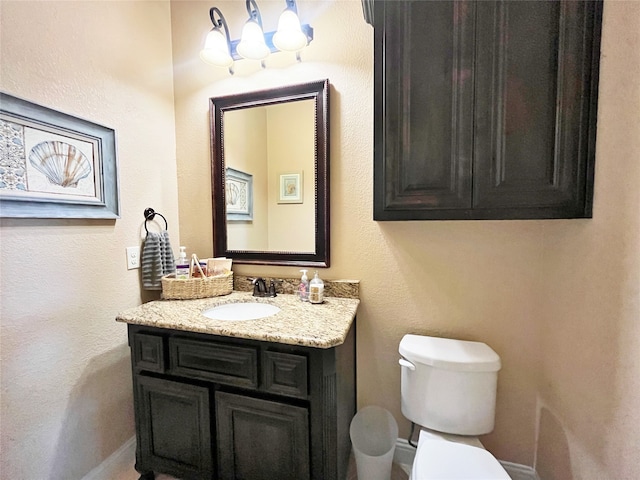 bathroom with toilet and vanity