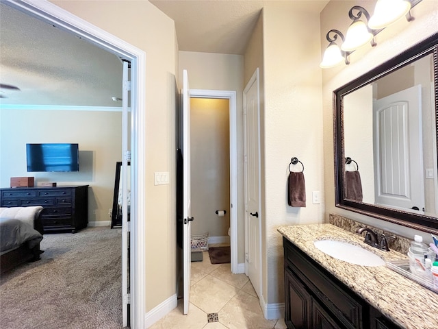 bathroom with tile patterned floors, vanity, and a textured ceiling