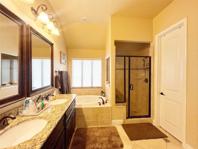 bathroom featuring vanity, lofted ceiling, independent shower and bath, and tile patterned flooring