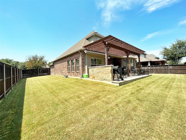 back of house with a pergola, a yard, and a patio