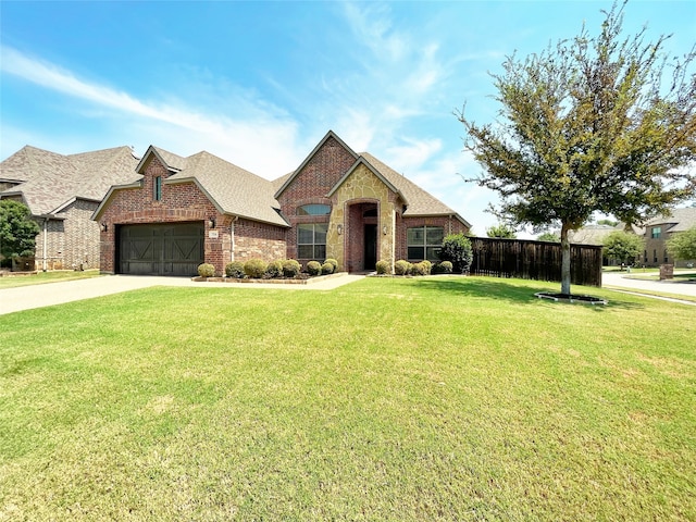 view of front of property featuring a garage and a front yard