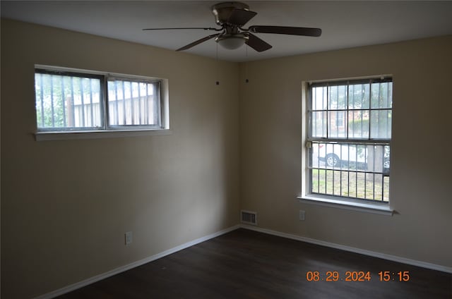 spare room with plenty of natural light, dark hardwood / wood-style flooring, and ceiling fan