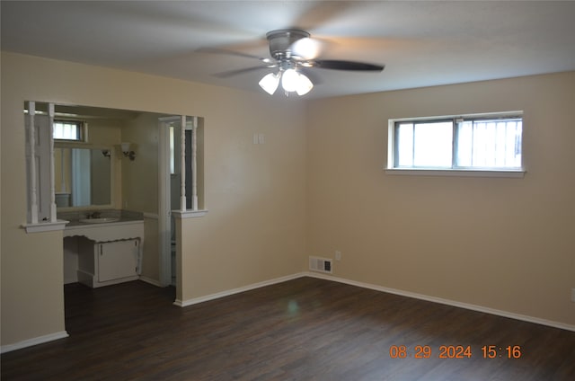 unfurnished room with ceiling fan, dark hardwood / wood-style flooring, and sink