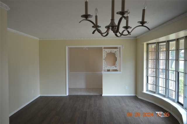 unfurnished room with ornamental molding, a chandelier, and dark hardwood / wood-style floors