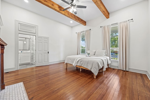 bedroom with ceiling fan, vaulted ceiling with beams, hardwood / wood-style flooring, and connected bathroom