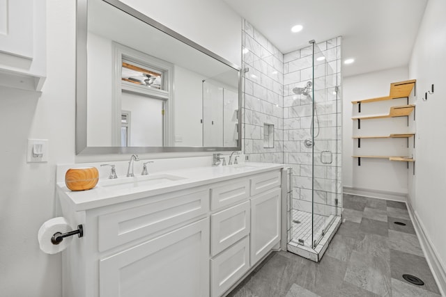 bathroom featuring vanity and a shower with door