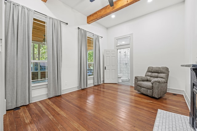 unfurnished room with a healthy amount of sunlight, beam ceiling, hardwood / wood-style floors, and ceiling fan