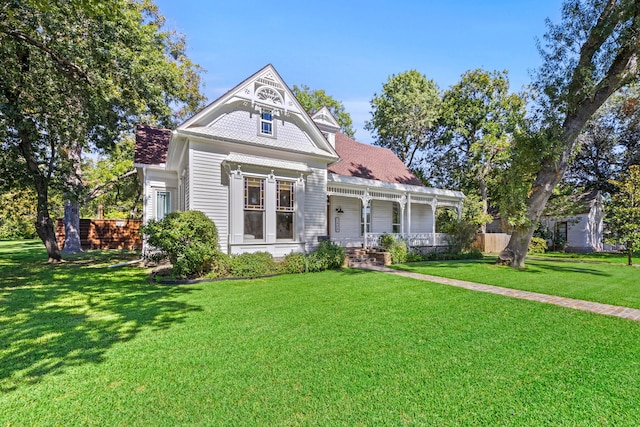 victorian house with covered porch and a front yard