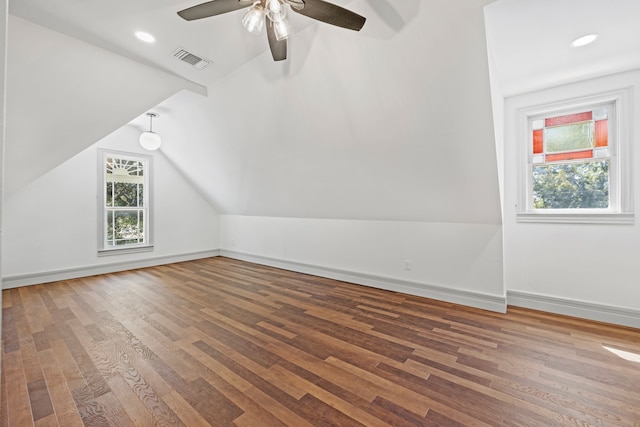 bonus room with wood-type flooring, vaulted ceiling, and a wealth of natural light