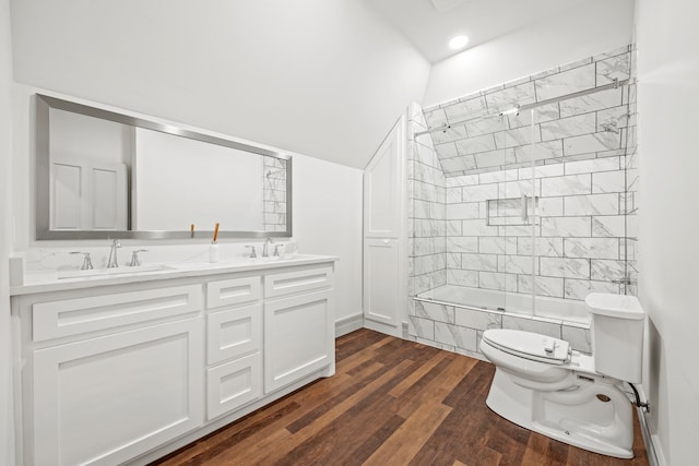 full bathroom with tiled shower / bath, vanity, hardwood / wood-style floors, and toilet